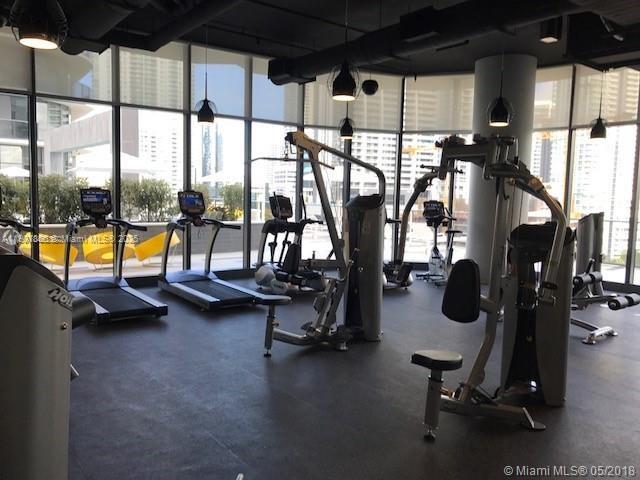 55 Southwest 9th Street, Unit 2510 Miami, FL 33130 - Photo 16 of 27 a view of gym equipment with large windows