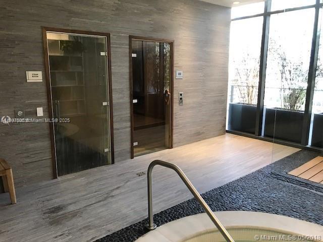 55 Southwest 9th Street, Unit 2510 Miami, FL 33130 - Photo 18 of 27 a bathroom with a granite countertop sink a mirror and shower