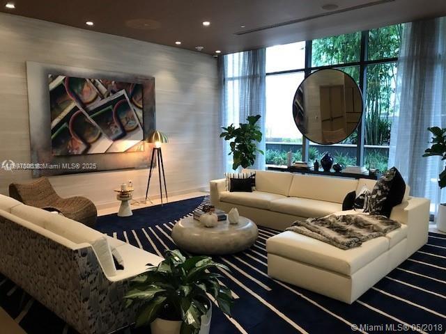 55 Southwest 9th Street, Unit 2510 Miami, FL 33130 - Photo 21 of 27 a living room with furniture and a mirror