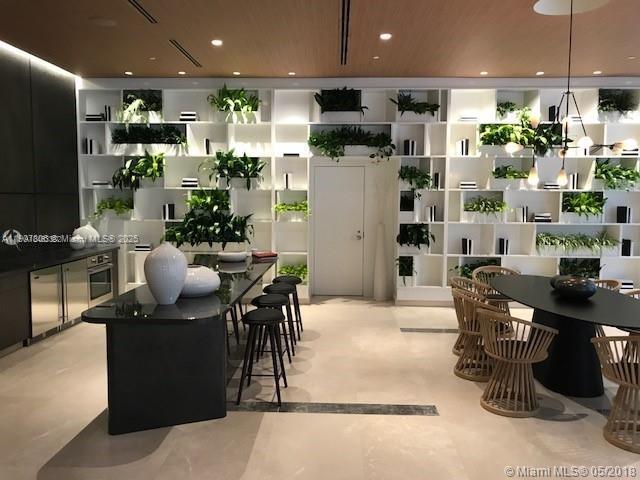 55 Southwest 9th Street, Unit 2510 Miami, FL 33130 - Photo 22 of 27 a kitchen with a sink stainless steel appliances and dining table