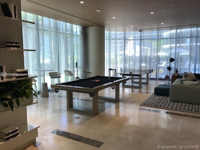55 Southwest 9th Street, Unit 2510 Miami, FL 33130 - Photo 26 of 27 a living room with furniture a rug and a large window