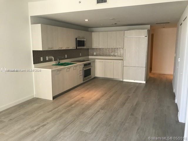 55 Southwest 9th Street, Unit 2510 Miami, FL 33130 - Photo 3 of 27 a kitchen with a white cabinets and white appliances