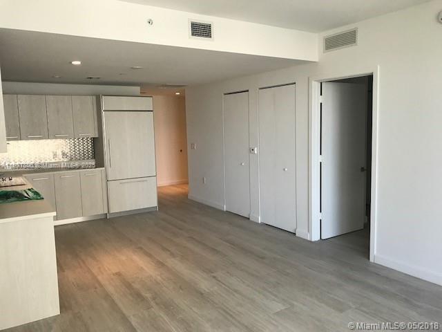 55 Southwest 9th Street, Unit 2510 Miami, FL 33130 - Photo 4 of 27 a view of a kitchen with a sink and a refrigerator
