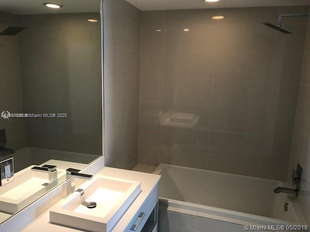 55 Southwest 9th Street, Unit 2510 Miami, FL 33130 - Photo 10 of 27 a bathroom with a sink and a mirror