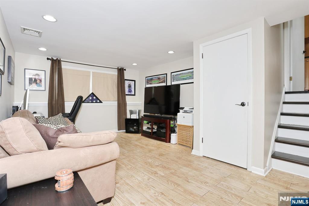 30 Brookfield Road Dumont, NJ 07628 - Photo 24 of 50 a living room with furniture and a flat screen tv