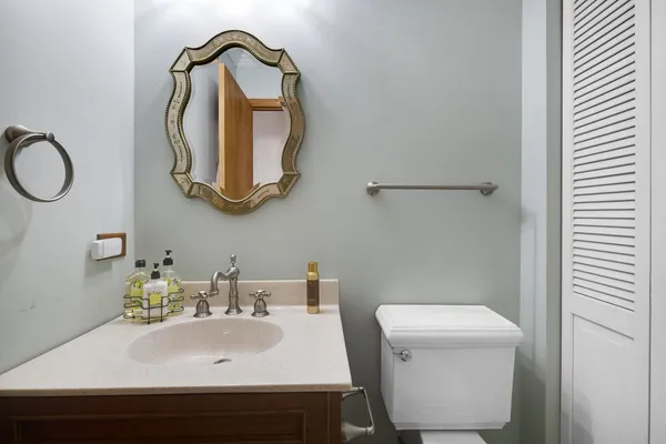a bathroom with a sink a toilet and a mirror