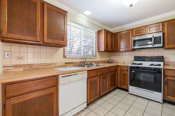 a kitchen with stainless steel appliances granite countertop a stove sink and microwave