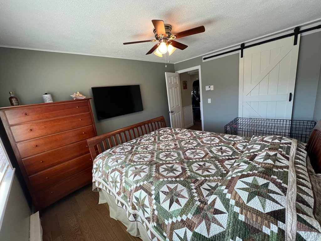 5 Turnpike Road, Unit 233 Townsend, MA 01469 - Photo 13 of 16 a bedroom with a bed and a flat screen tv