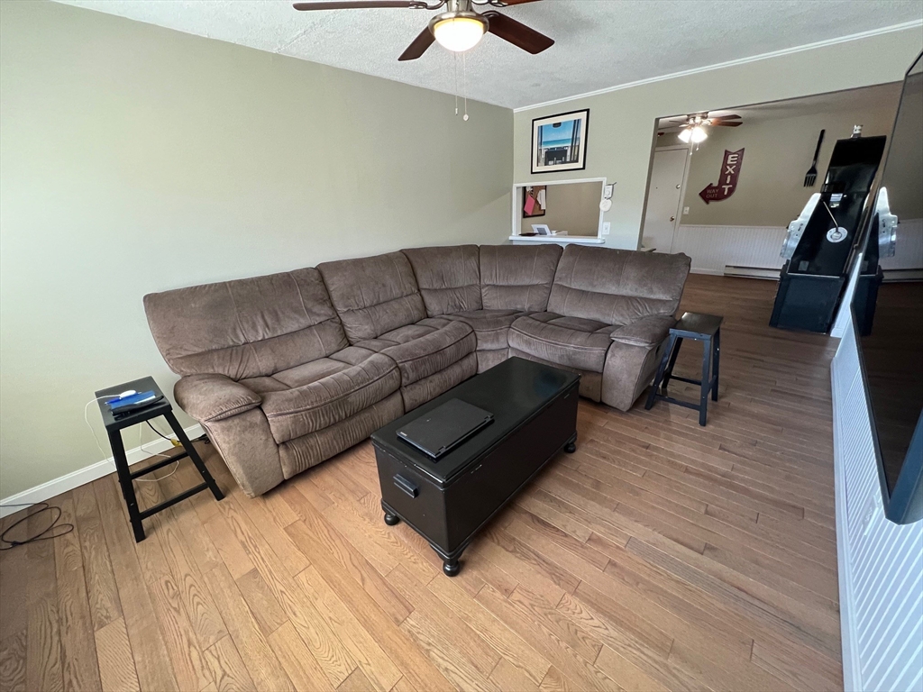 5 Turnpike Road, Unit 233 Townsend, MA 01469 - Photo 9 of 16 a living room with furniture and a wooden floor