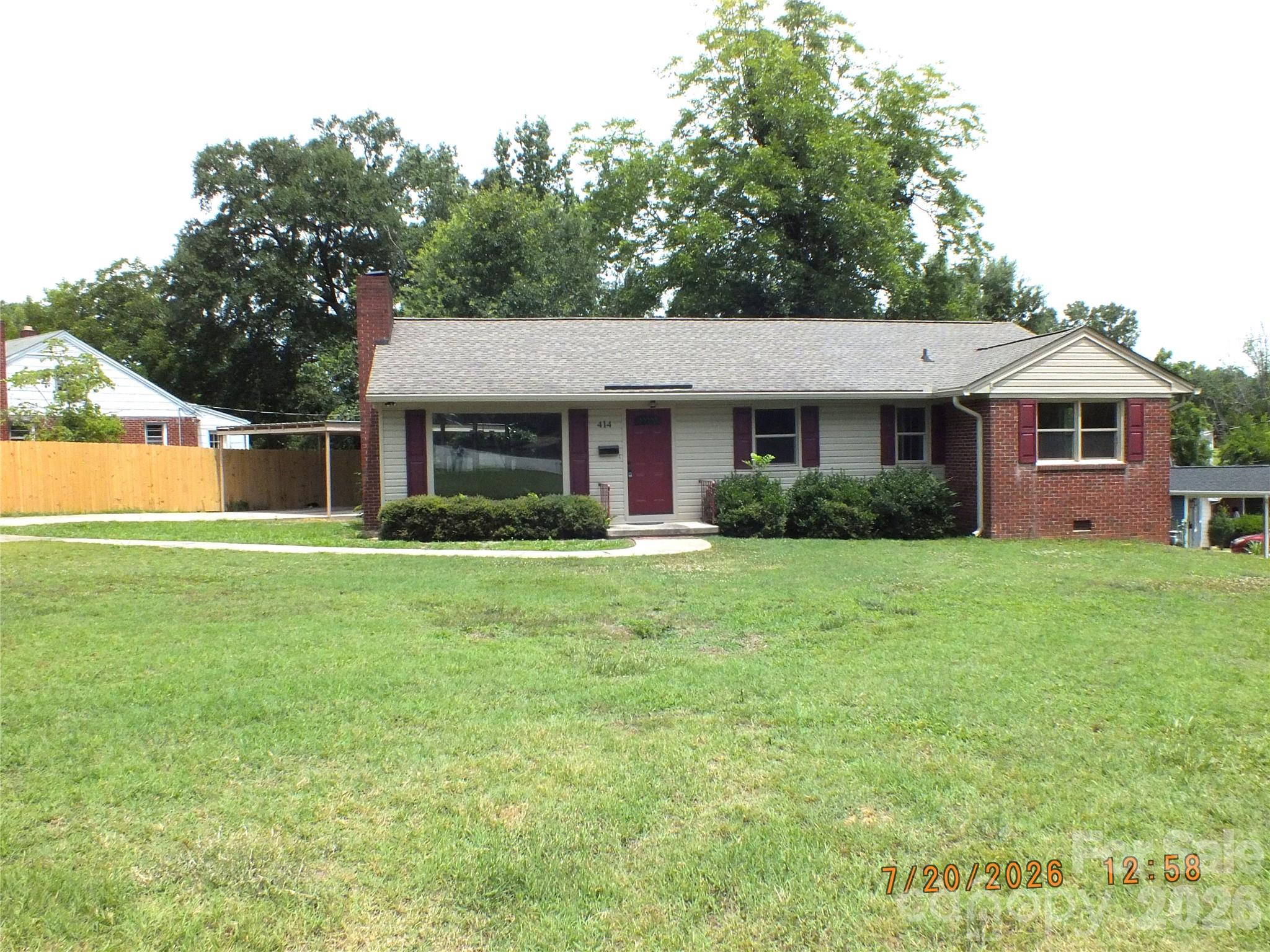 414 West Springs Street Lancaster, SC 29720 - Photo 1 of 22 a front view of a house with a garden