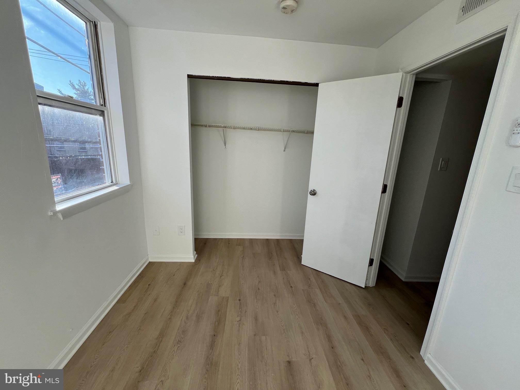626 South 8th Street, Unit 2 Philadelphia, PA 19147 - Photo 14 of 14 a view of an empty room with wooden floor and a window