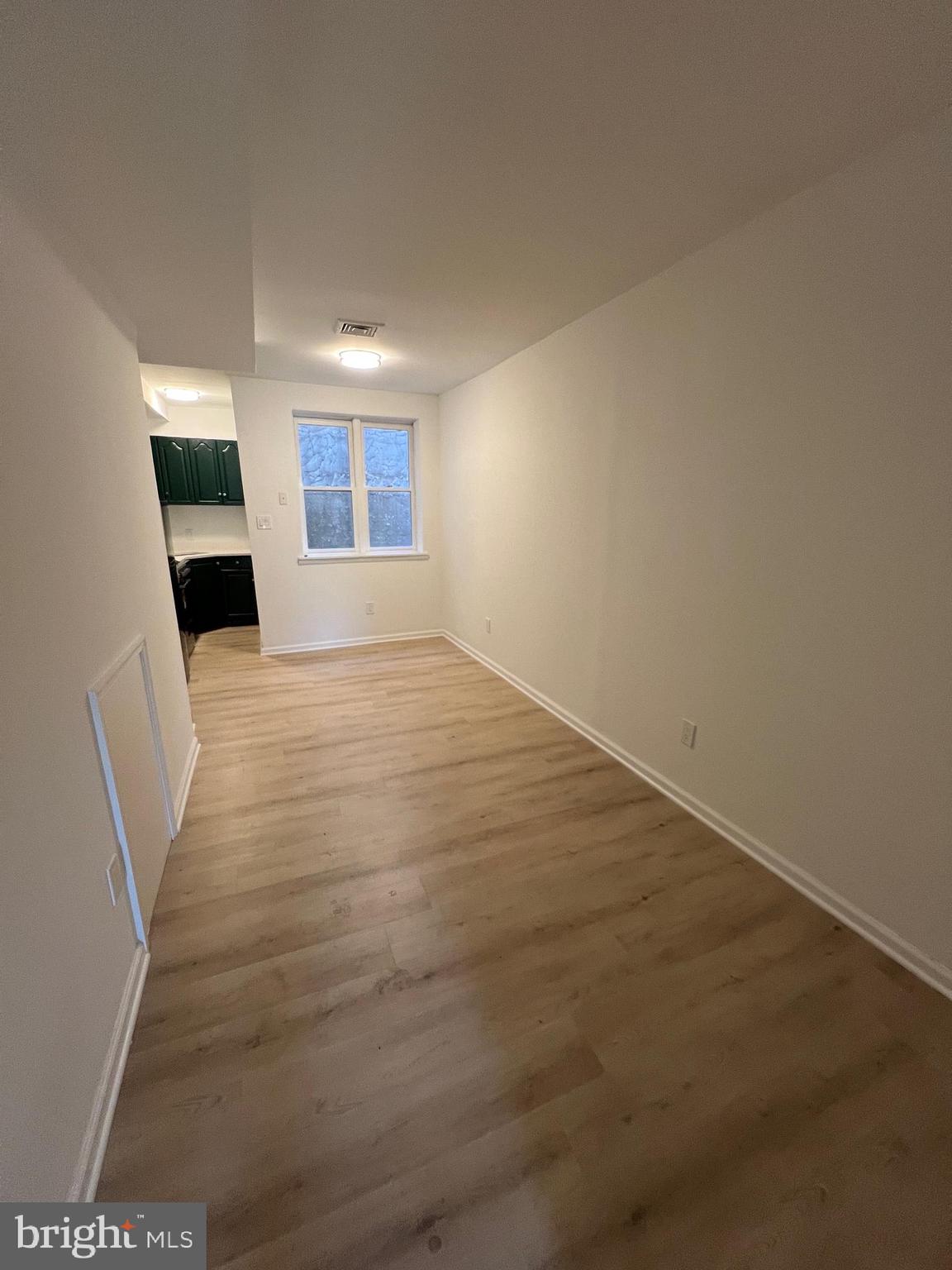 626 South 8th Street, Unit 2 Philadelphia, PA 19147 - Photo 4 of 14 an empty room with wooden floor and windows
