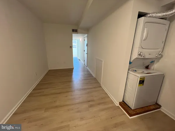 a view of a room with wooden floor and white walls