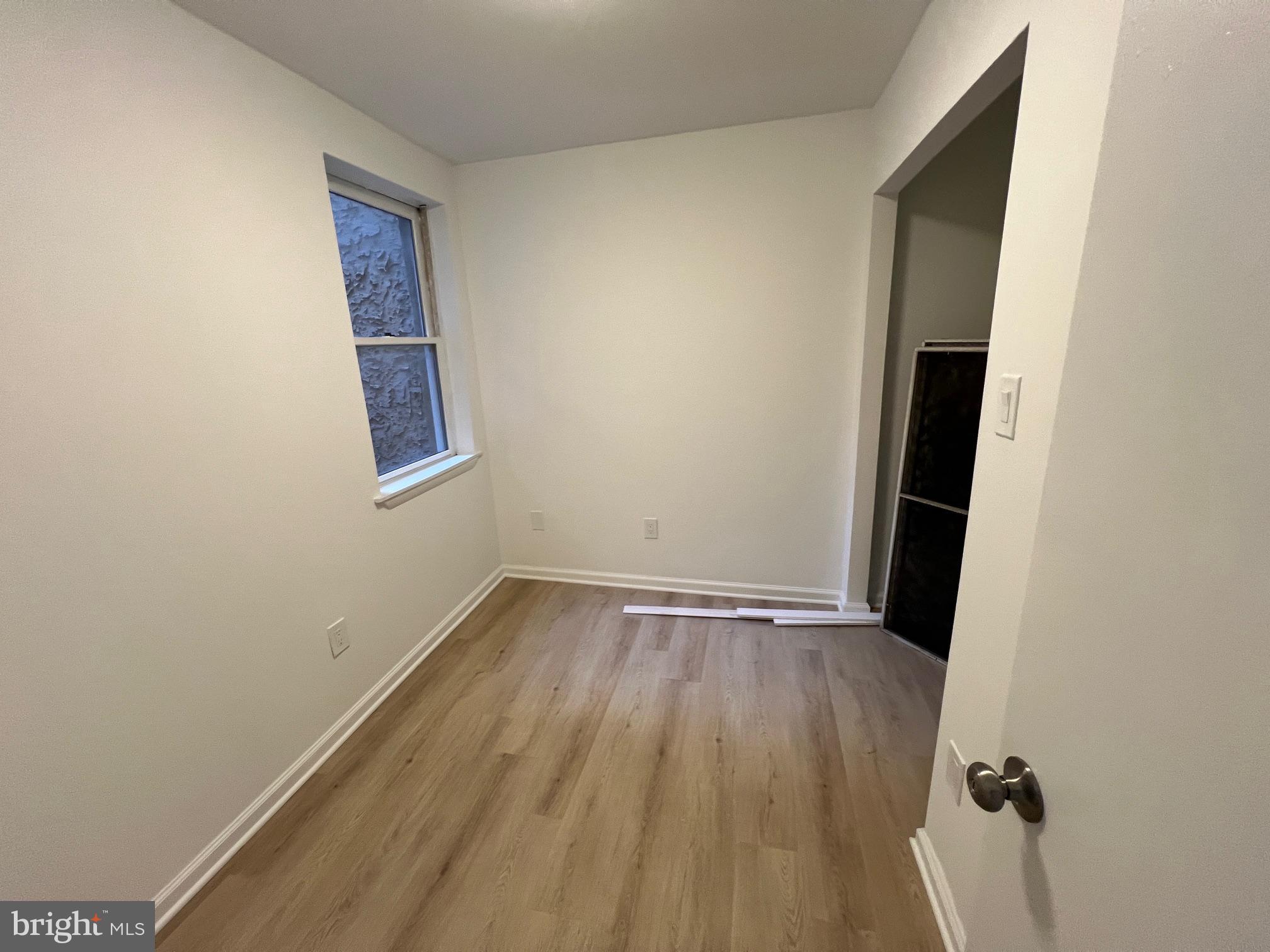 626 South 8th Street, Unit 2 Philadelphia, PA 19147 - Photo 9 of 14 an empty room with wooden floor and windows