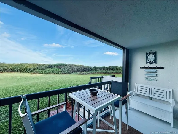 a bedroom with two beds and a large window
