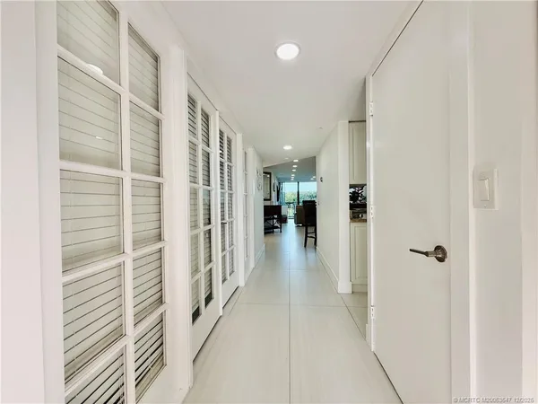 a kitchen with stainless steel appliances granite countertop a sink and a stove top oven with white countertops