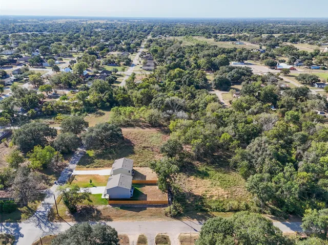 an aerial view of a houses with a yard