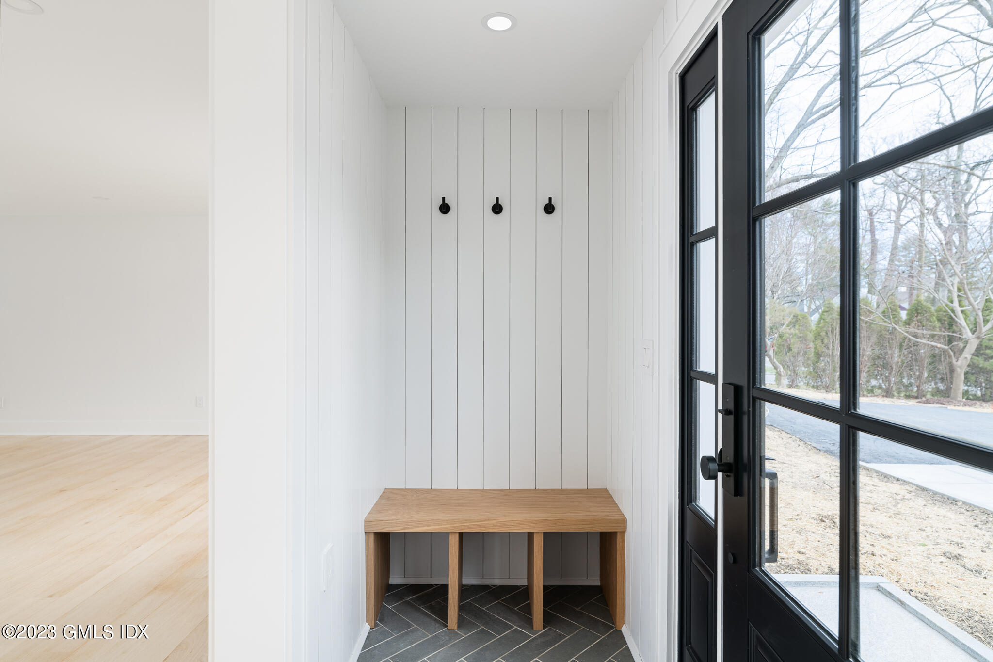 27 Summit Road Riverside, CT 06878 - Photo 2 of 38 a hallway with a table and a potted plant