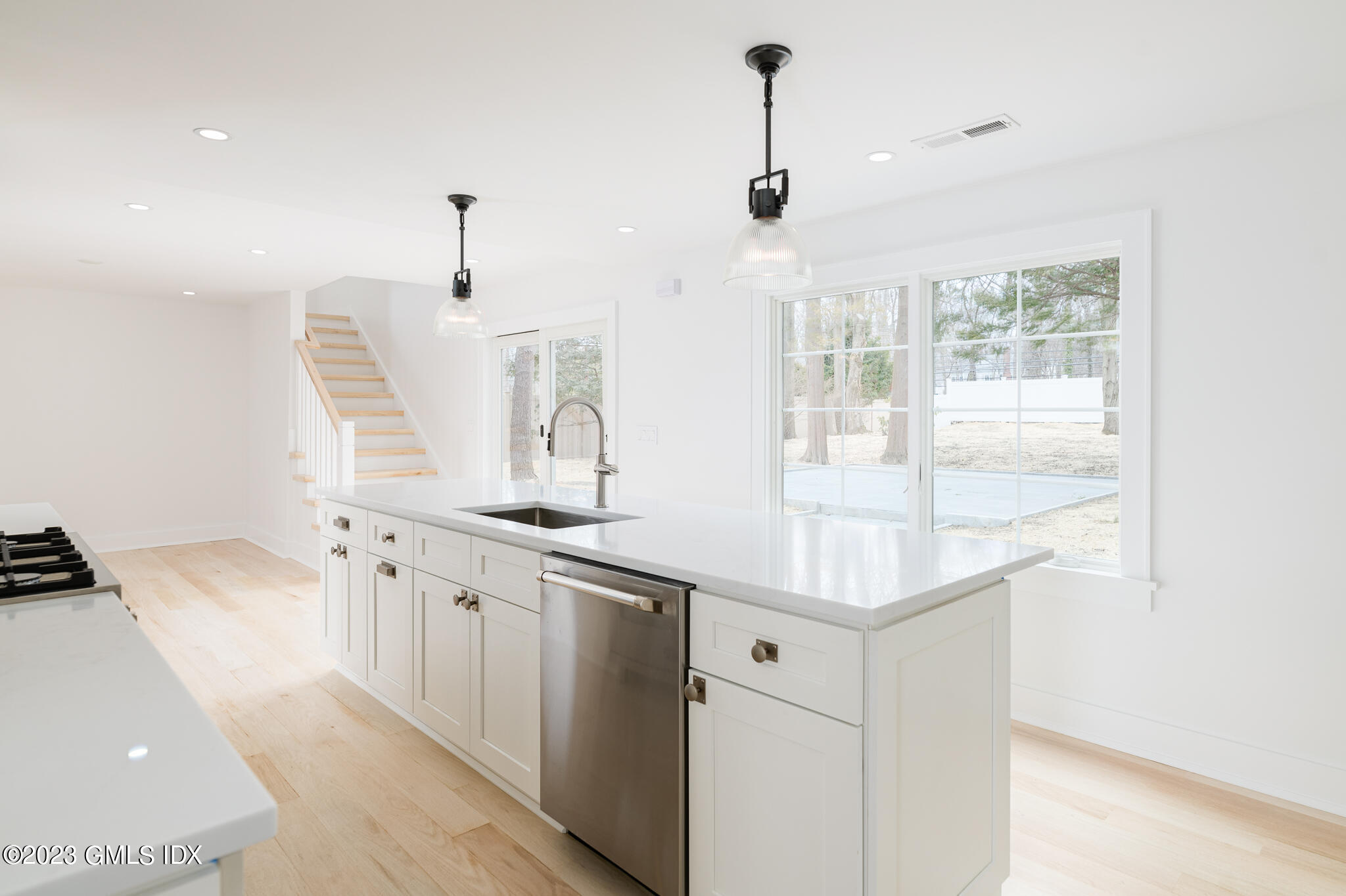 27 Summit Road Riverside, CT 06878 - Photo 7 of 38 a kitchen with stainless steel appliances granite countertop a sink and a refrigerator