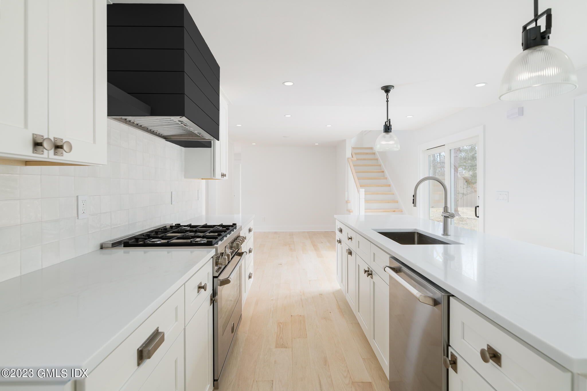 27 Summit Road Riverside, CT 06878 - Photo 8 of 38 a kitchen with stainless steel appliances granite countertop a sink and a stove