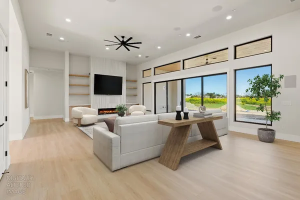 a large kitchen with stainless steel appliances a large counter top a stove and a wooden floors