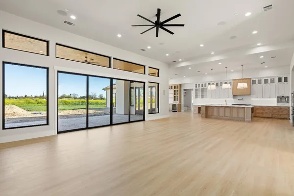 a large kitchen with stainless steel appliances kitchen island granite countertop a large kitchen island a stove a sink and a refrigerator
