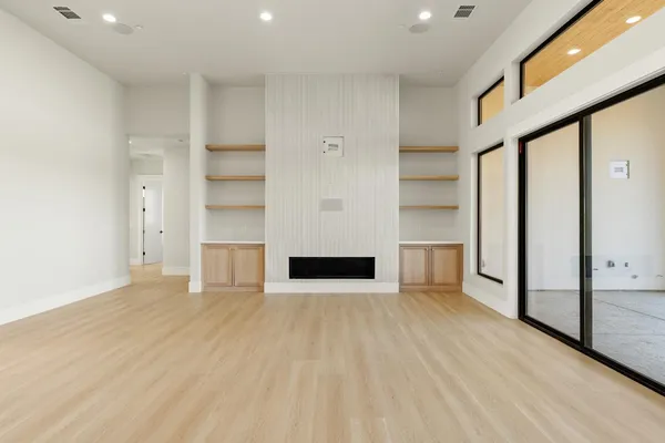 a open kitchen with white cabinets and wooden floor
