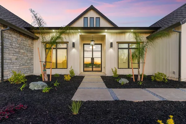 a view of empty room with wooden floor and window