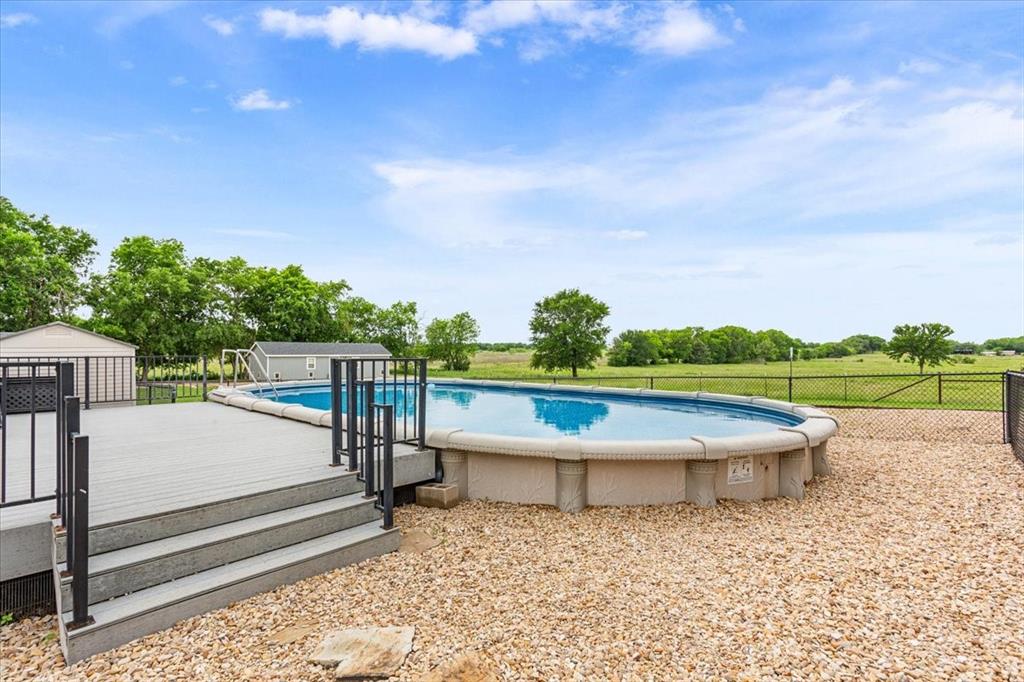 259 County Road 149 Riesel, TX 76682 - Photo 33 of 40 View of swimming pool featuring fence and an outdoor structure