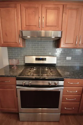 a stove top oven sitting inside of a kitchen