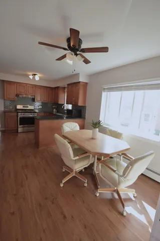 a view of a dining room with furniture window and wooden floor