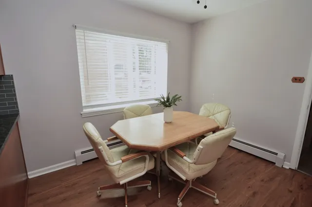 a view of a dining room with furniture and wooden floor