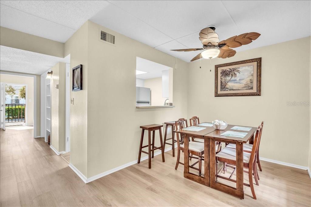 8911 Blind Pass Road, Unit 209 St. Pete Beach, FL 33706 - Photo 11 of 21 a view of a dining room with furniture and wooden floor