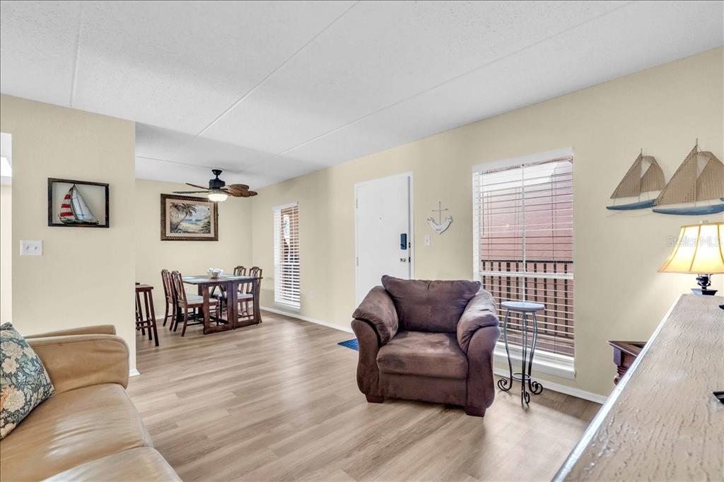 8911 Blind Pass Road, Unit 209 St. Pete Beach, FL 33706 - Photo 12 of 21 a living room with furniture and a wooden floor