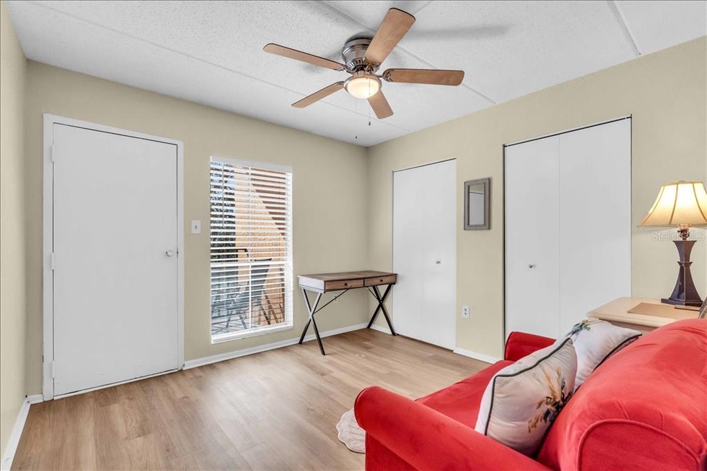 8911 Blind Pass Road, Unit 209 St. Pete Beach, FL 33706 - Photo 17 of 21 a living room with furniture and a wooden floor
