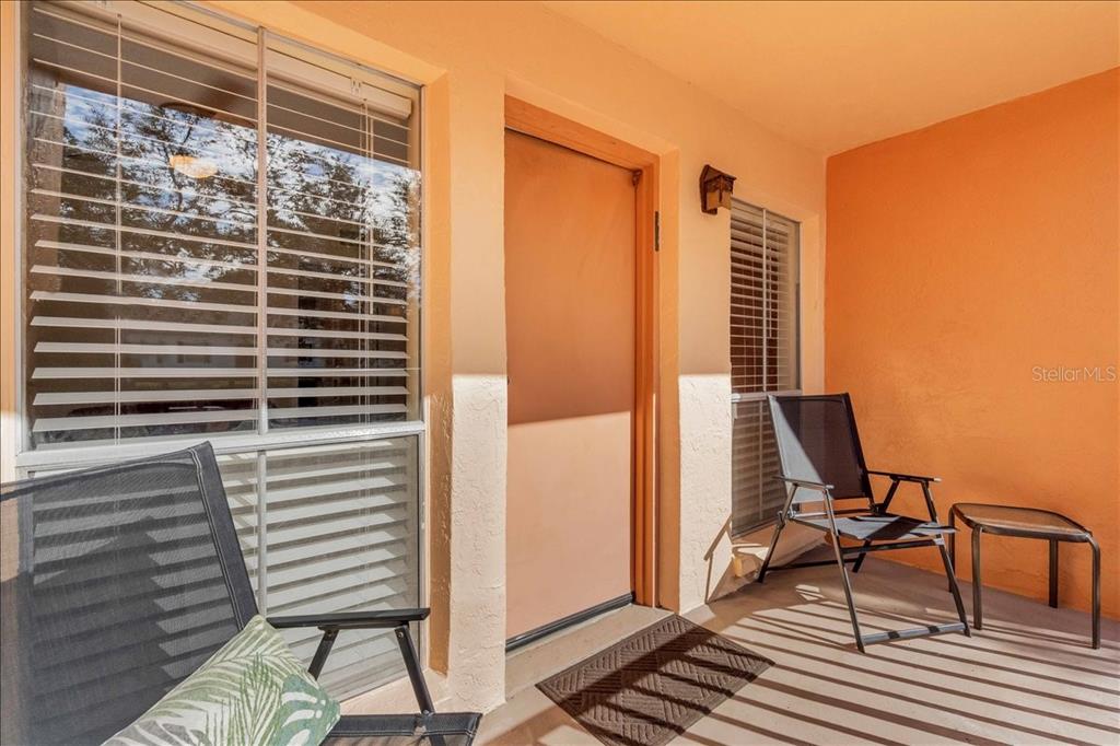 8911 Blind Pass Road, Unit 209 St. Pete Beach, FL 33706 - Photo 20 of 21 a view of a balcony with chairs