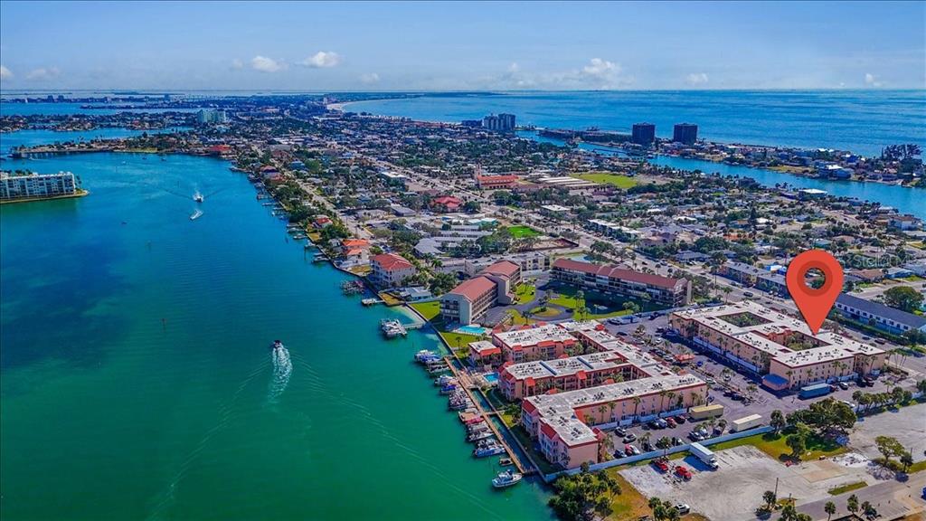 8911 Blind Pass Road, Unit 209 St. Pete Beach, FL 33706 - Photo 2 of 21 an aerial view of a house with a yard