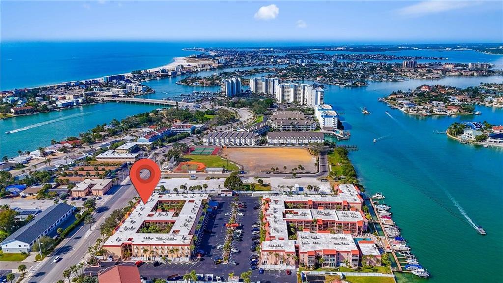 8911 Blind Pass Road, Unit 209 St. Pete Beach, FL 33706 - Photo 6 of 21 an aerial view of residential building and lake