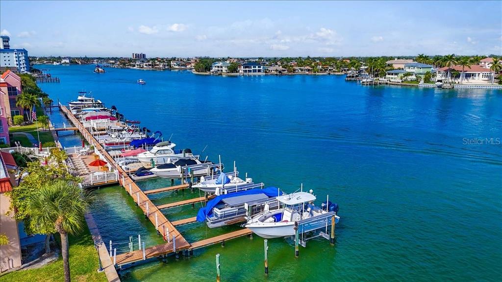 8911 Blind Pass Road, Unit 209 St. Pete Beach, FL 33706 - Photo 7 of 21 a view of a house with outdoor seating space and lake view