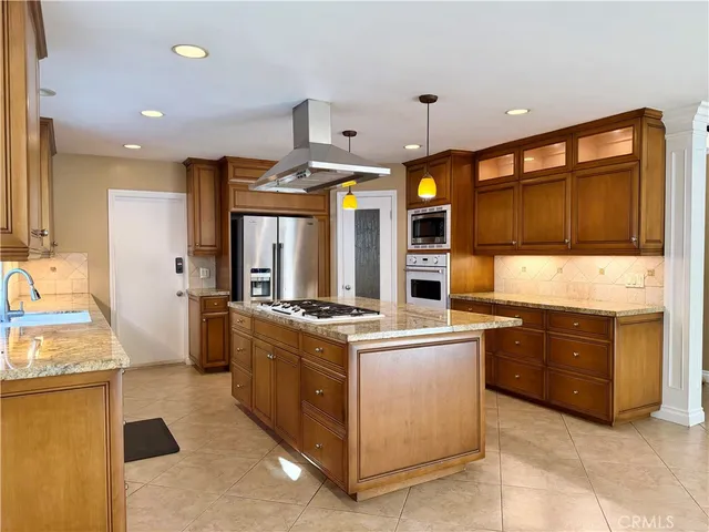 a kitchen with stainless steel appliances granite countertop a stove and a refrigerator