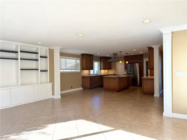a view of a kitchen with furniture and an empty room