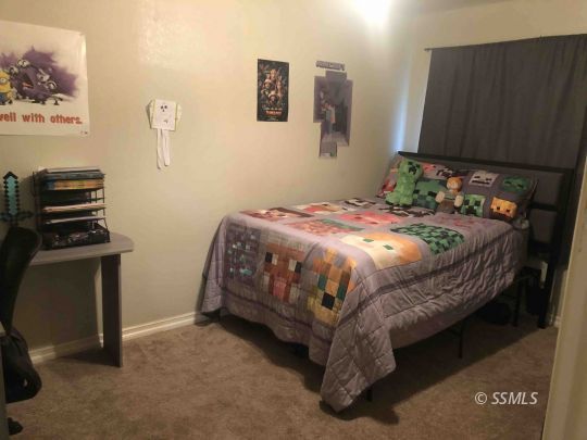 324 Mari Court Ridgecrest, CA 93555 - Photo 10 of 16 a bedroom with a bed and a tv
