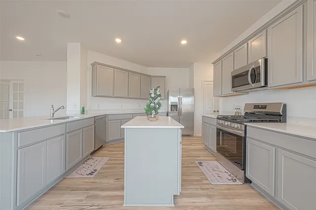 a kitchen with a sink stove and microwave