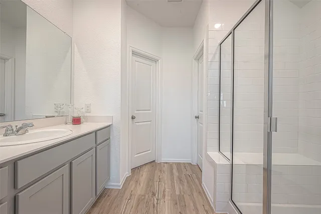 a bathroom with a double vanity sink and mirror