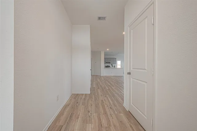 a view of a room with wooden floor