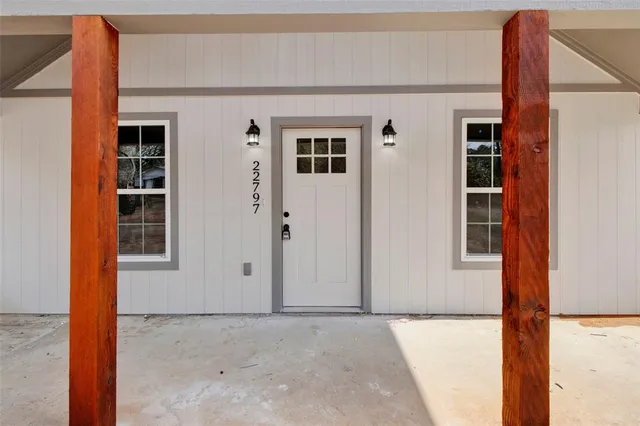 a view of kitchen with microwave and cabinets