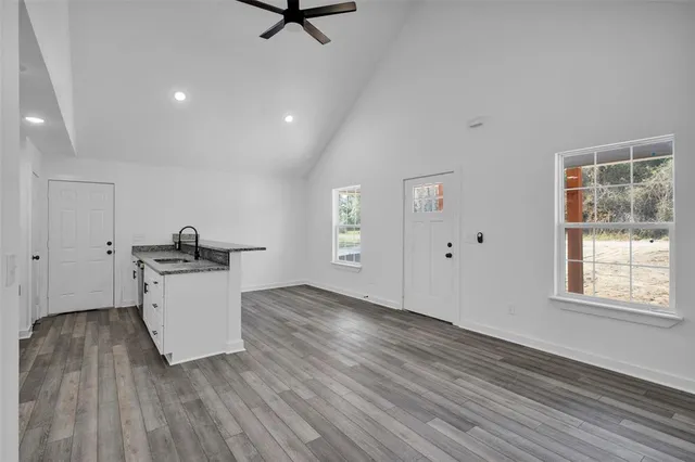 a view of a kitchen with sink and microwave area
