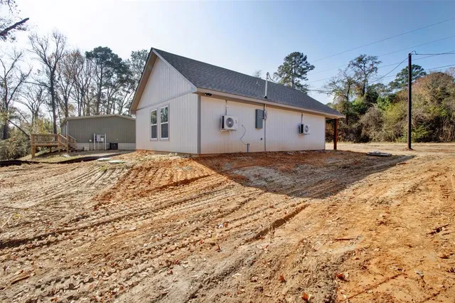 a front view of a house with a yard covered in snow