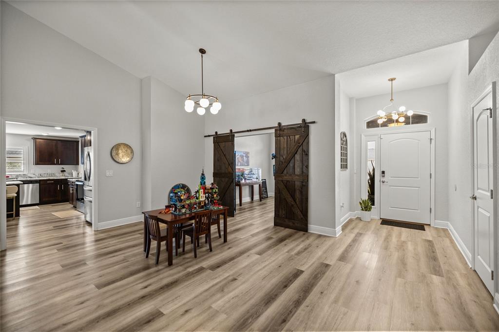 4160 Southwest 100th Street Ocala, FL 34476 - Photo 11 of 42 a view of a livingroom with furniture wooden floor and a chandelier