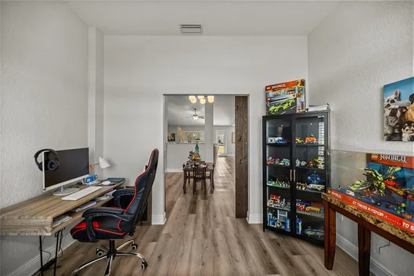 a view of a workspace with furniture and wooden floor